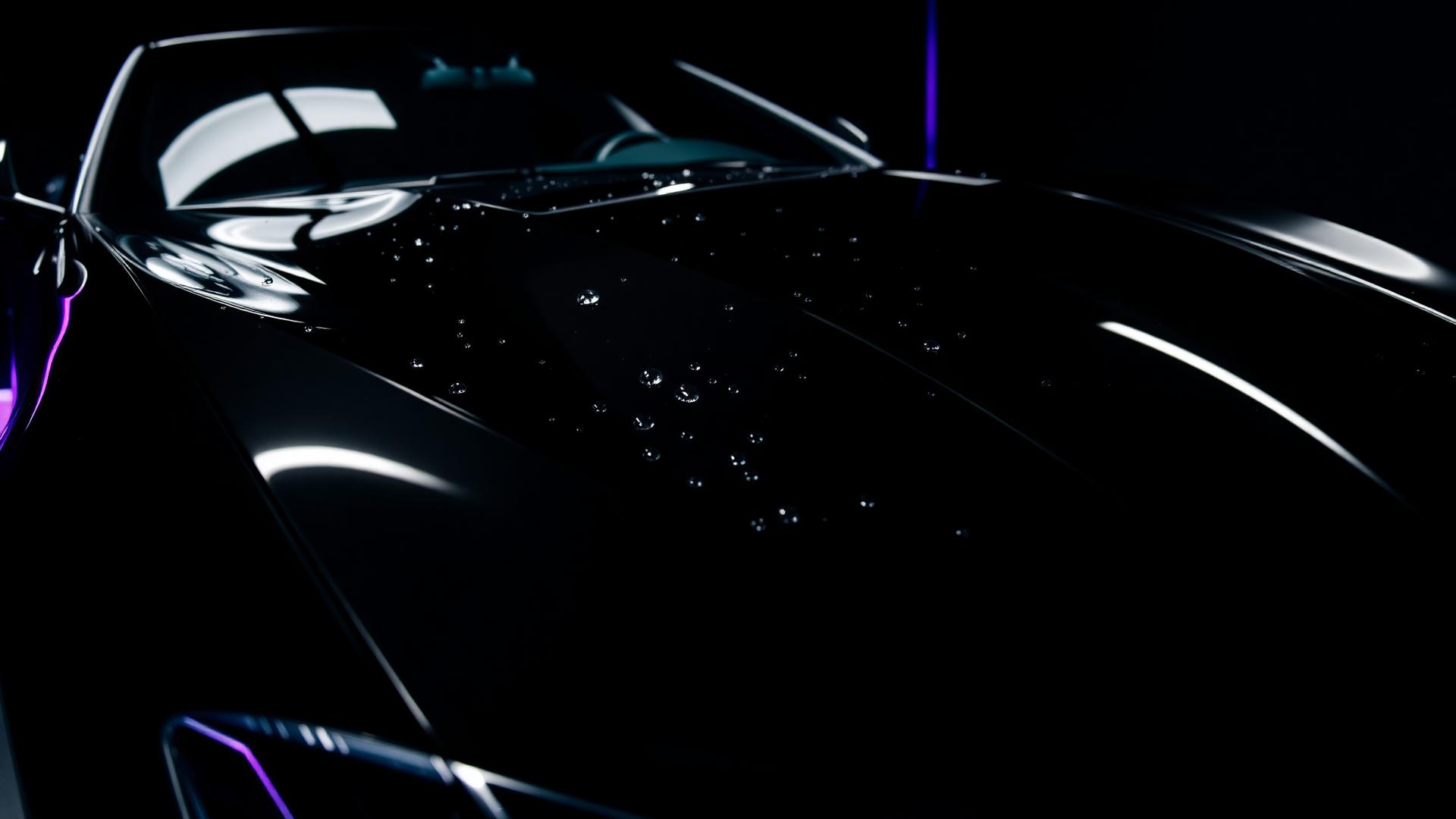 Ceramic-coated black luxury car with water beading
